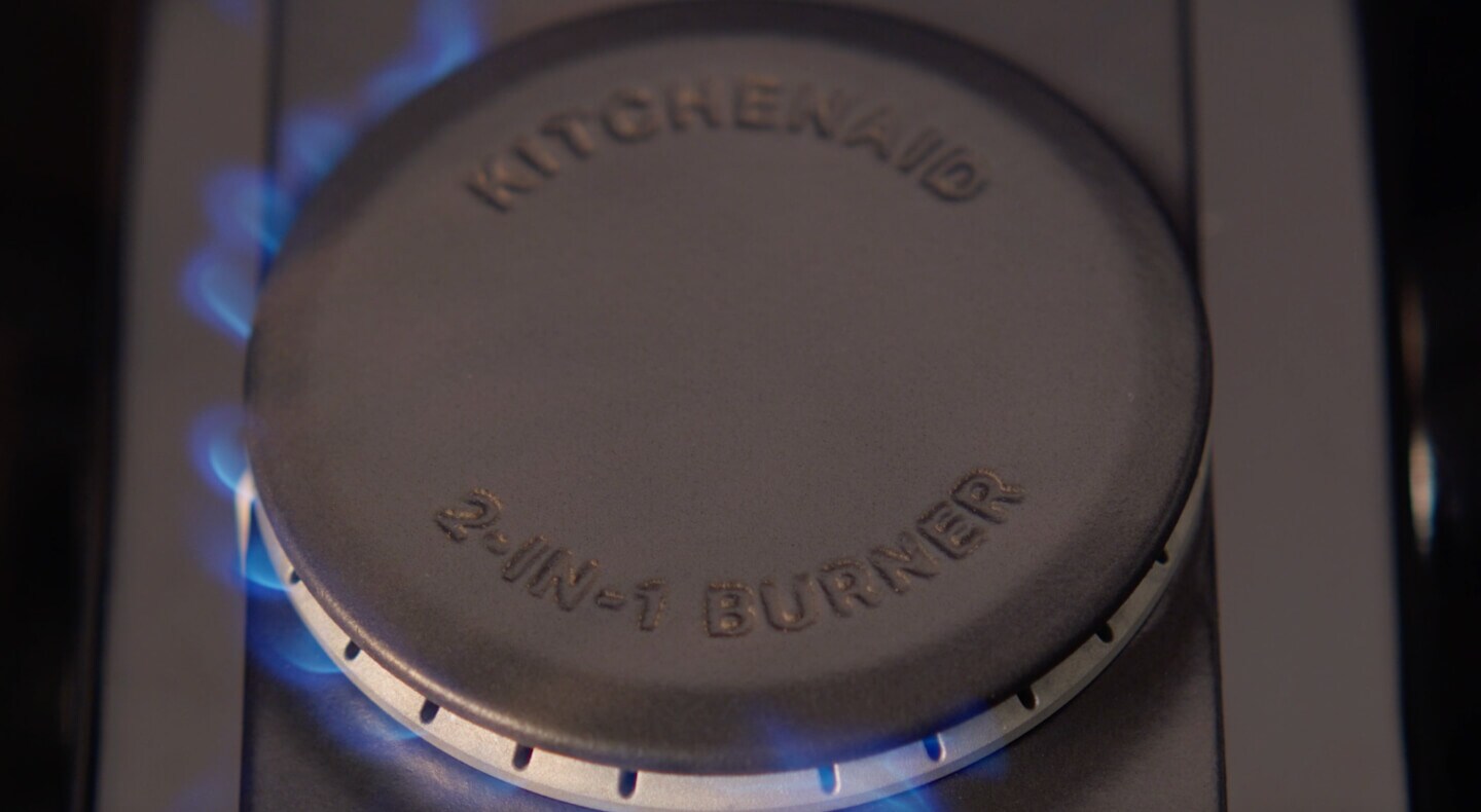 A closeup of a KitchenAid® 2-in-1 Burner on a gas range