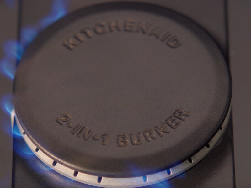 A closeup of a KitchenAid® 2-in-1 Burner on a gas range