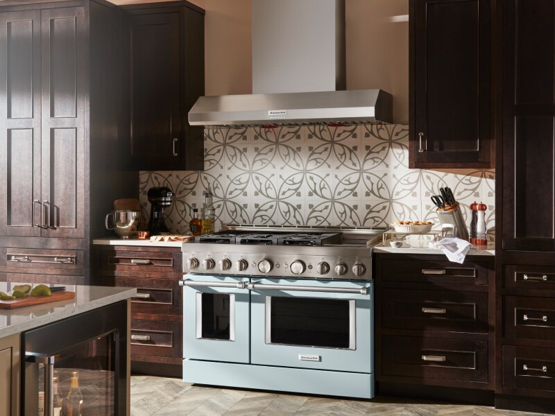 KitchenAid® wall mount range hood above decorative backsplash and range