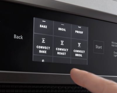 Finger selecting an oven setting