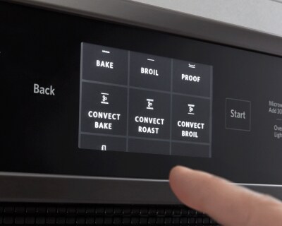 Finger selecting an oven setting