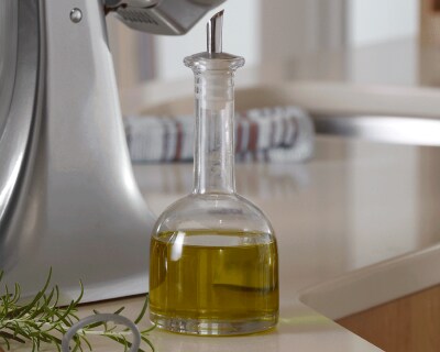 Glass bottle of oil on a counter 