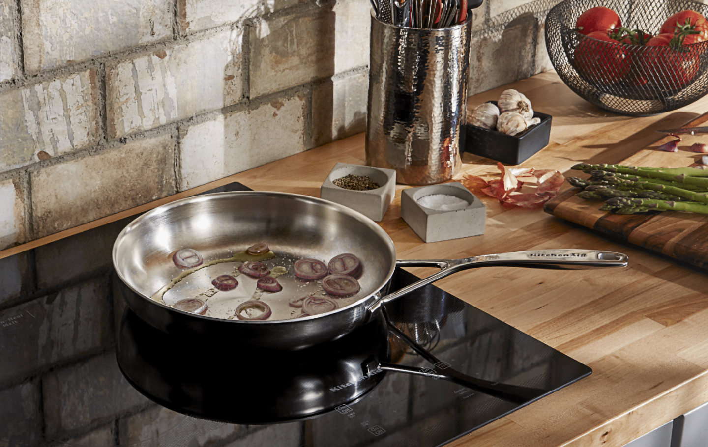 Onions caramelizing on a KitchenAid® cooktop Onions caramelizing on a KitchenAid® cooktop