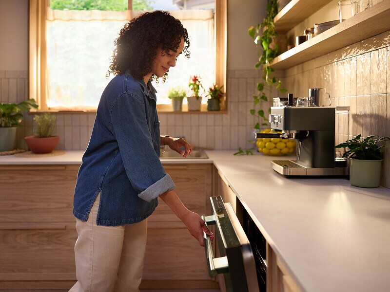 A person closing the door to the dishwasher