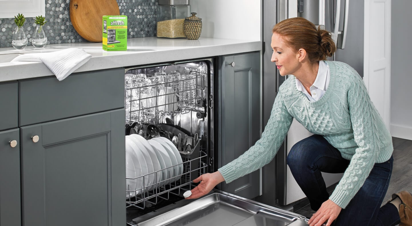 A person using an affresh® dishwasher cleaner tablet to clean their dishwasher A person using an affresh® dishwasher cleaner tablet to clean their dishwasher