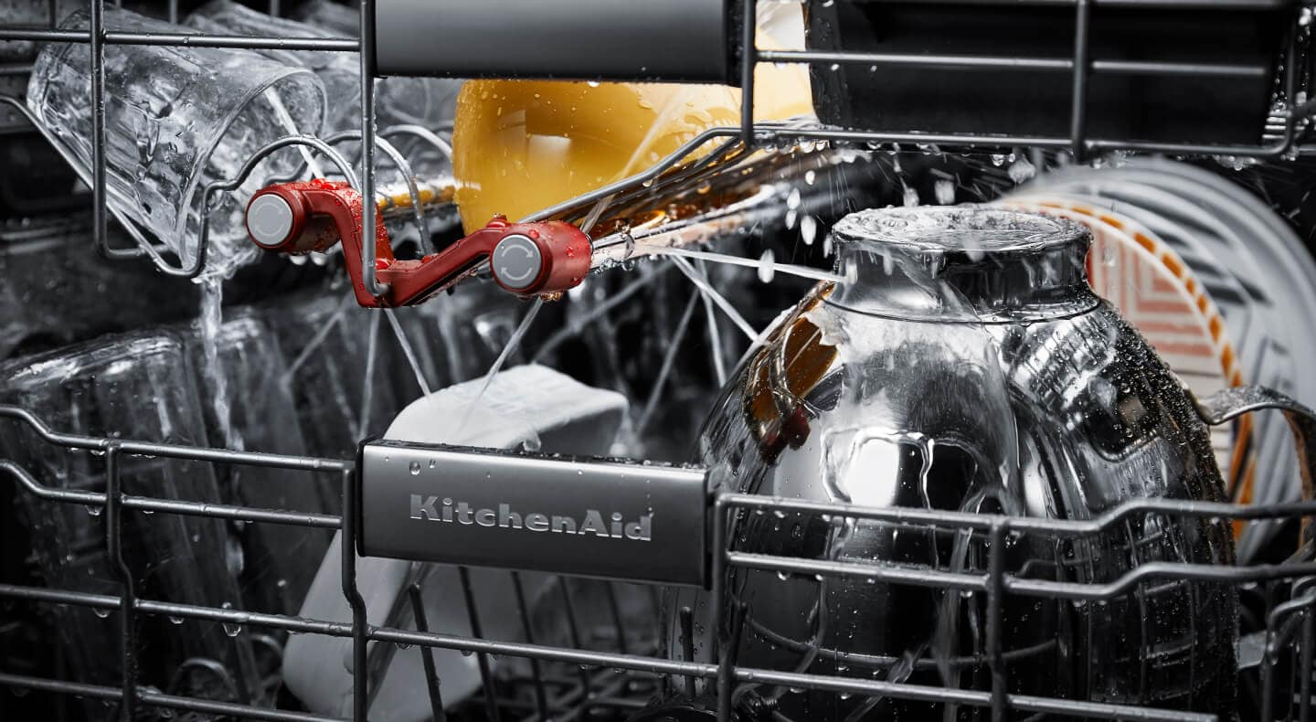 Dishes getting cleaned inside a KitchenAid® dishwasher Dishes getting cleaned inside a KitchenAid® dishwasher