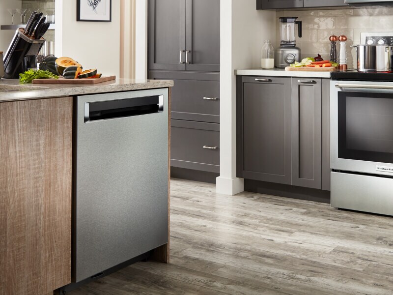 Silver KitchenAid® appliances in a kitchen with brown cabinets Silver KitchenAid® appliances in a kitchen with brown cabinets