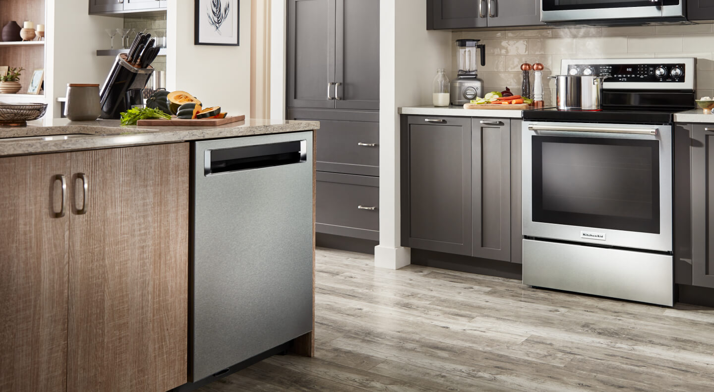 Silver KitchenAid® appliances in a kitchen with brown cabinets Silver KitchenAid® appliances in a kitchen with brown cabinets
