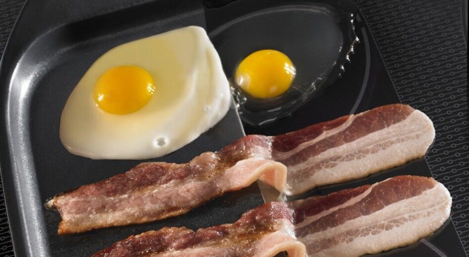 Bacon and eggs sizzling on an induction cooktop Bacon and eggs sizzling on an induction cooktop