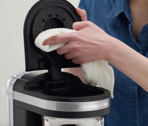 Hand cleaning drip coffee maker shower head with a cloth