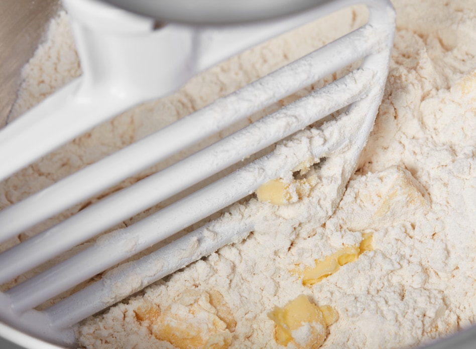 Up close view of pastry blender mixing flour and butter in stand mixer Up close view of pastry blender mixing flour and butter in stand mixer