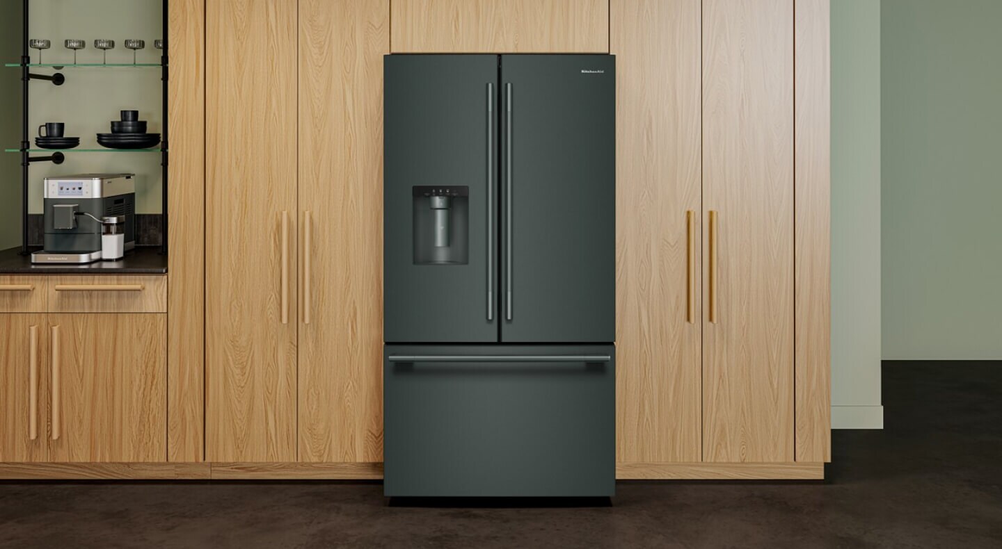 A KitchenAid® French Door Refrigerator surrounded by cabinetry