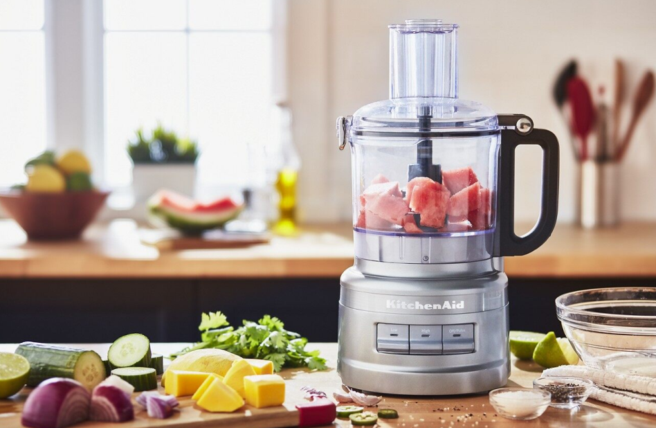 Watermelon in a food processor on counter surrounded by ingredients Watermelon in a food processor on counter surrounded by ingredients