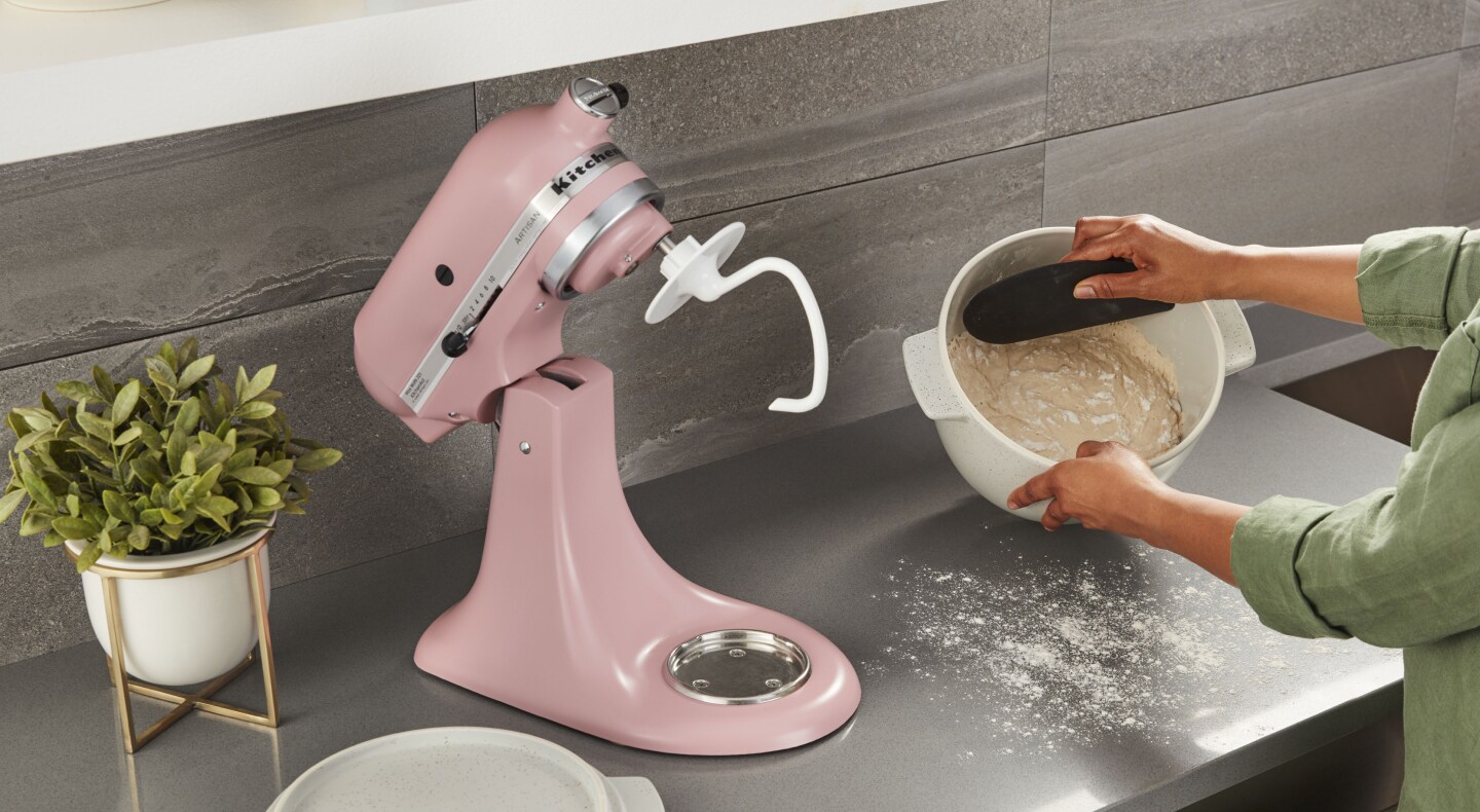 Scraping dough from a mixer bowl Scraping dough from a mixer bowl