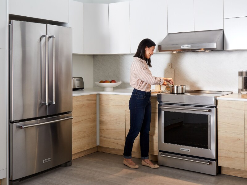 A person boiling water on an oven