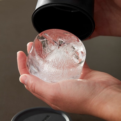 Person removing ice from ice mold