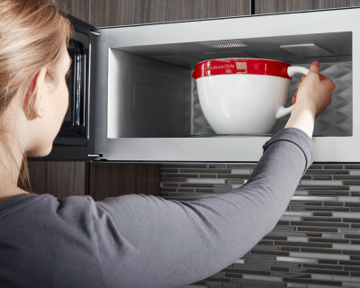 Bowl being placed inside a microwave