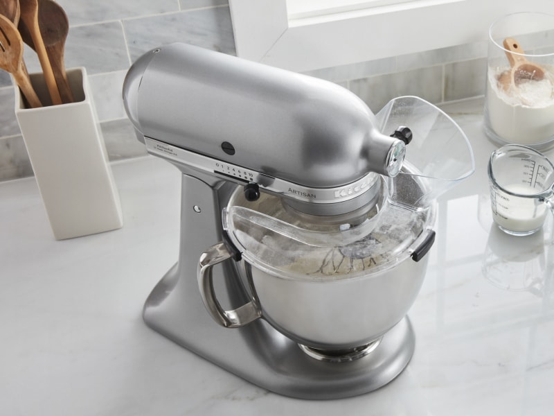 Stainless steel stand mixer next to to cake batter ingredients Stainless steel stand mixer next to to cake batter ingredients