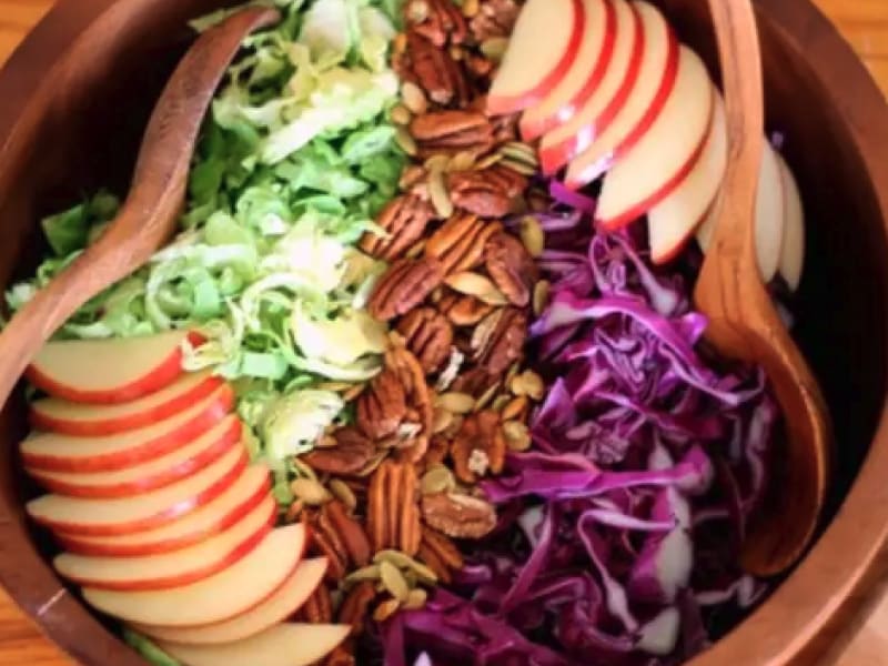 A closeup of a Brussels slaw salad with maple tahini dressing.