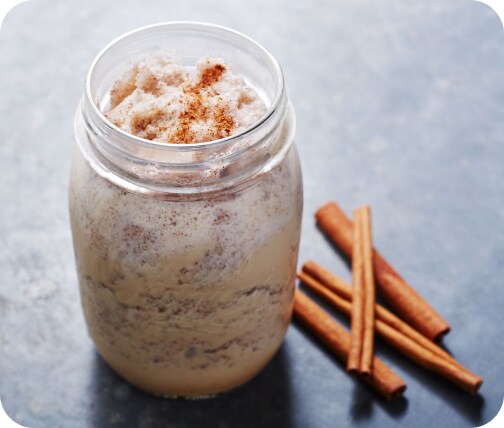 Mason jar filled with cold brew coffee recipe and cinnamon sticks