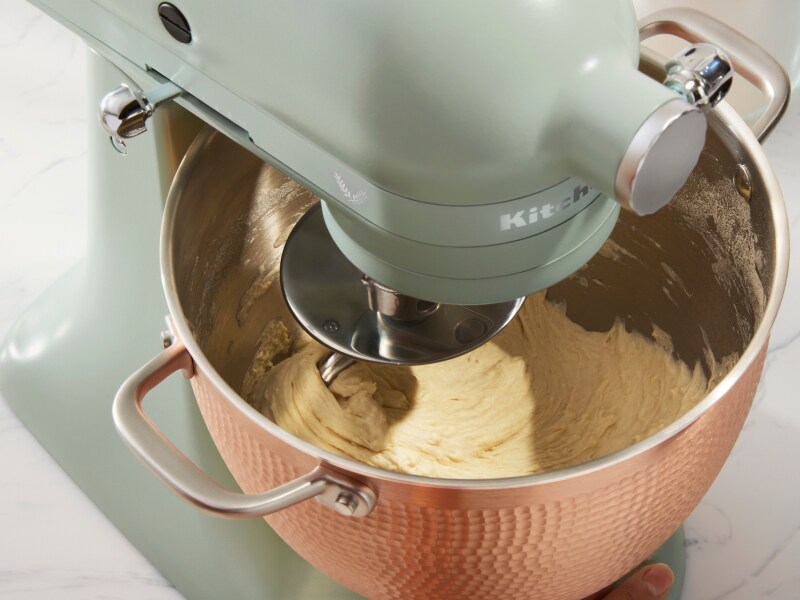 Blue KitchenAid® stand mixer mixing dough