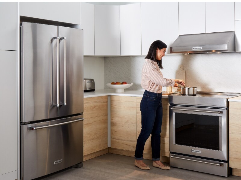 Person cooking on a stainless steel range