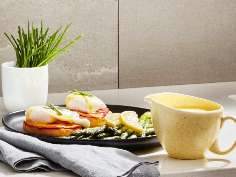 Eggs Benedict on a plate at a table