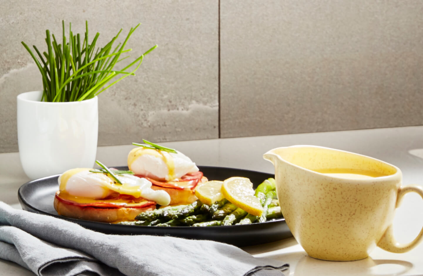 Eggs Benedict on a plate at a table