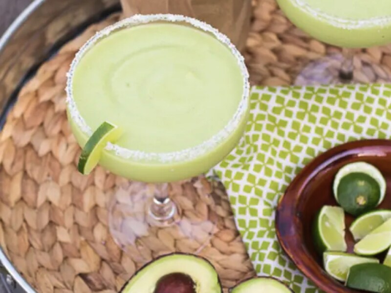 Frozen avocado margaritas with lime garnish