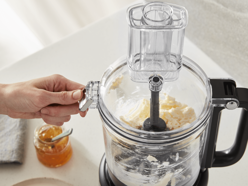 Person using food processor to process ingredients