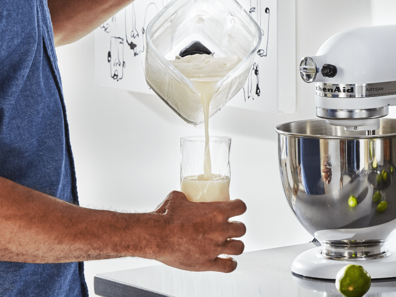 Person pouring horchata from blender into glass