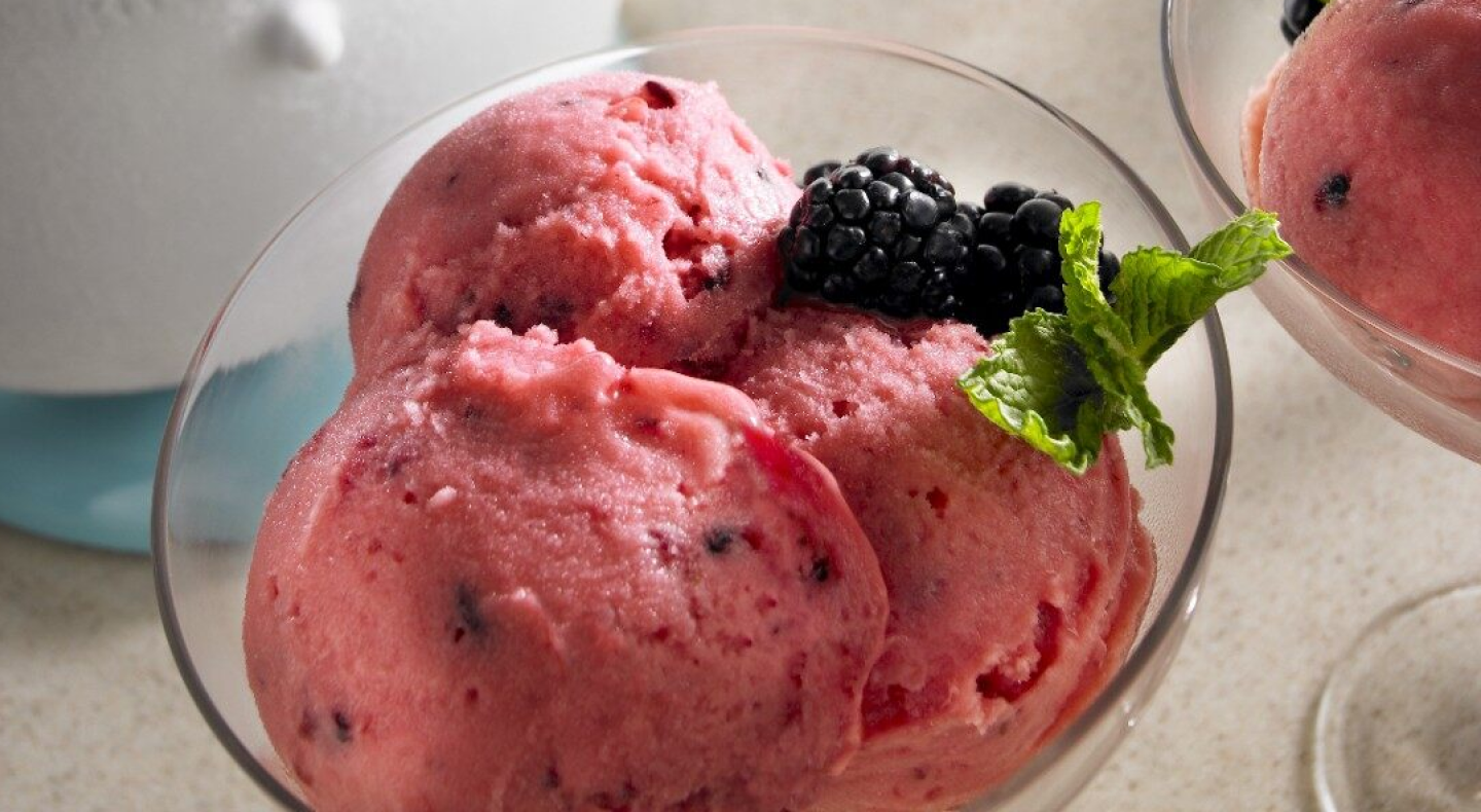 Strawberry ice cream in a glass dish, topped with berries and garnish. Strawberry ice cream in a glass dish, topped with berries and garnish.