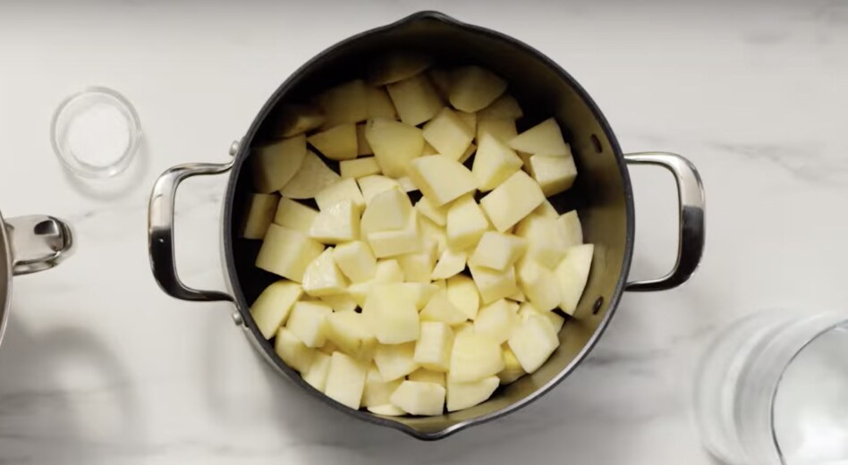 Cubed, peeled potatoes in a large pot Cubed, peeled potatoes in a large pot