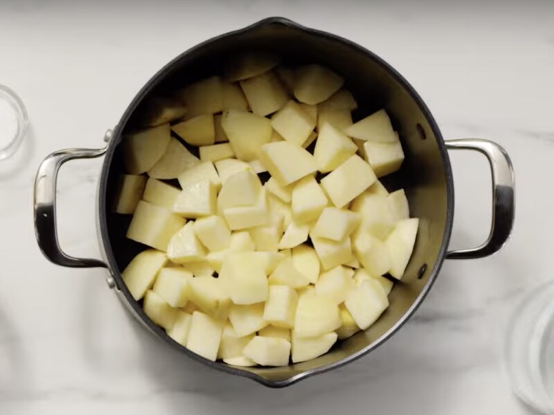 Cubed, peeled potatoes in a large pot Cubed, peeled potatoes in a large pot