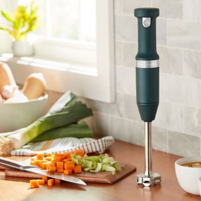 KitchenAid® immersion blender on countertop with chopped vegetables