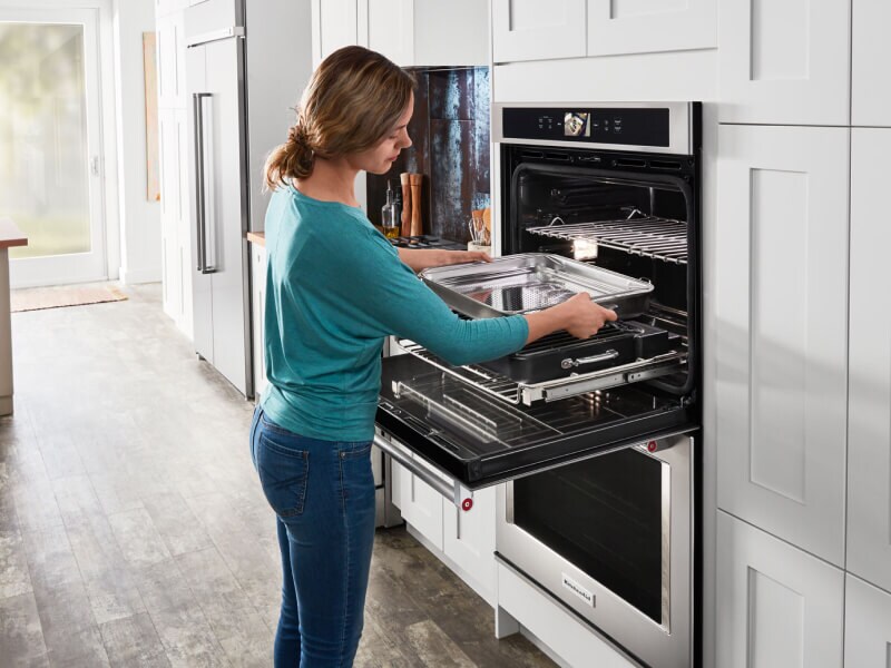 Person prepping their KitchenAid® oven to make ribs. Person prepping their KitchenAid® oven to make ribs.