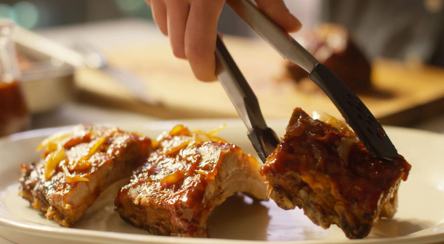 Three pieces of oven baked ribs with sauce. Three pieces of oven baked ribs with sauce.