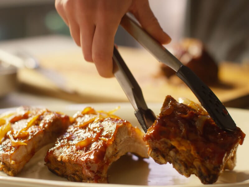 Three pieces of oven baked ribs with sauce. Three pieces of oven baked ribs with sauce.