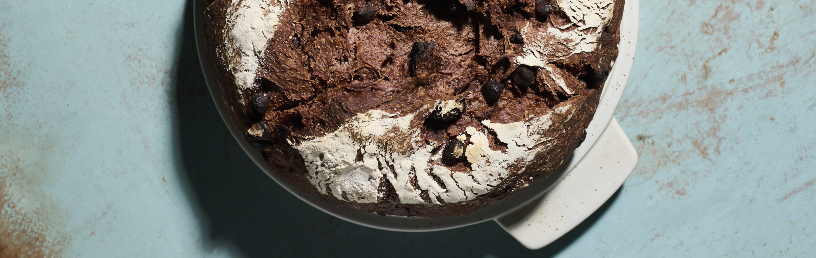 Close-up of top of rye bread loaf on counter