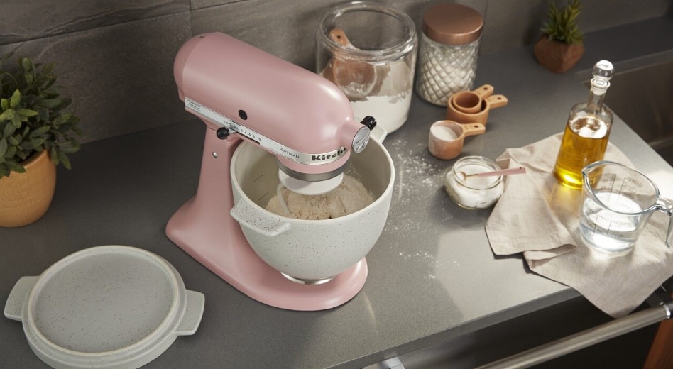 Woman filling a container with water from a refrigerator Stand mixer kneading sandwich bread dough