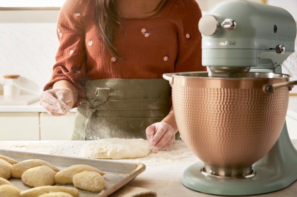 Scone dough being sprinkled with flour next to KitchenAid® stand mixer Scone dough being sprinkled with flour next to KitchenAid® stand mixer