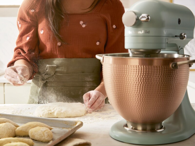 Scone dough being sprinkled with flour next to KitchenAid® stand mixer Scone dough being sprinkled with flour next to KitchenAid® stand mixer