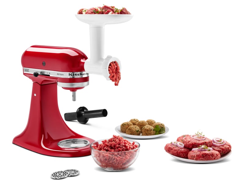 KitchenAid® stand mixer and meat grinder attachment grinding meat into bowl with plate of short rib patties and meatballs KitchenAid® stand mixer and meat grinder attachment grinding meat into bowl with plate of short rib patties and meatballs