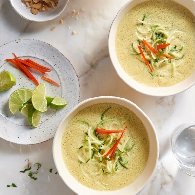 Two bowls of curried coconut soup from Yummly recipe