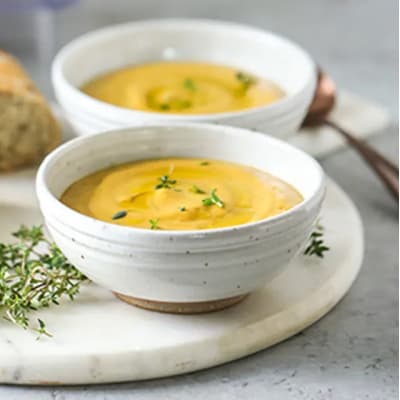 Two bowls of creamy roasted vegetable soup from Yummly recipe