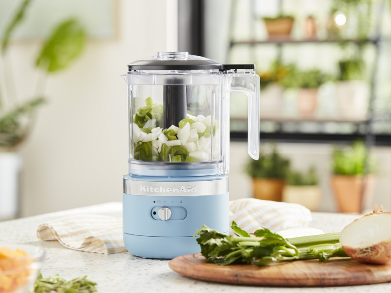 A KitchenAid® food processor filled with celery and onions