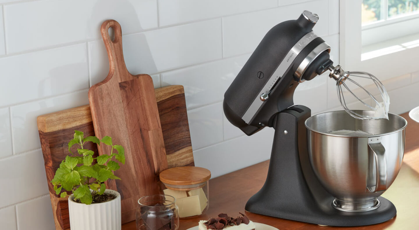 A black KitchenAid® stand mixer and various kitchen items on a countertop A black KitchenAid® stand mixer and various kitchen items on a countertop