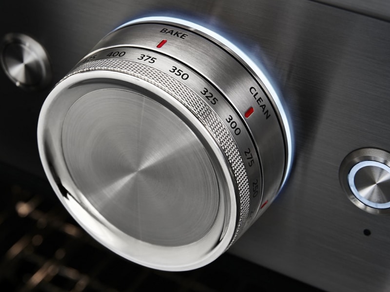 Close-up of oven temperature controls set to bake