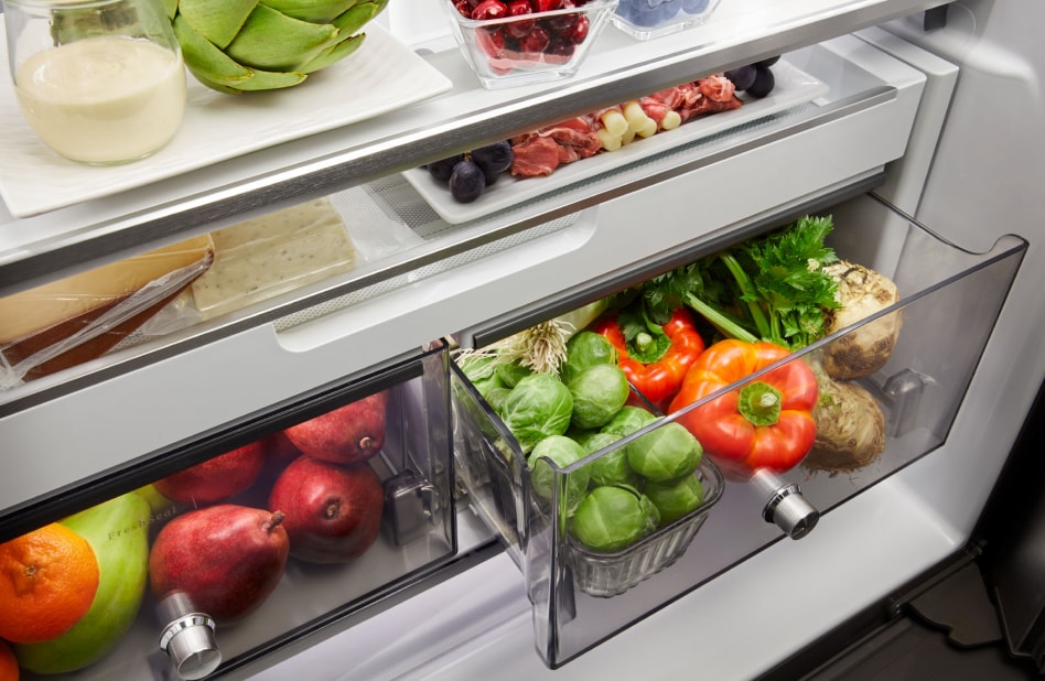 Crisper drawers containing apples, pears, peppers and various vegetables. Crisper drawers containing apples, pears, peppers and various vegetables.