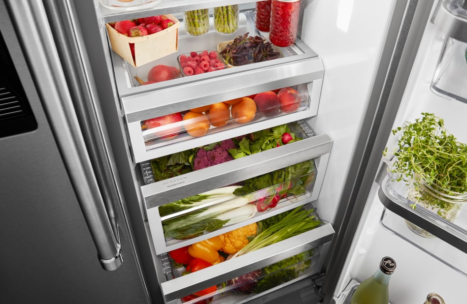 Various fruits and vegetables stored in crisper drawers. Various fruits and vegetables stored in crisper drawers.